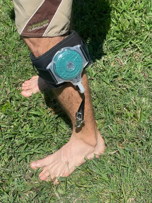 eFoilgc rider wearing the eFoilSolutions retractable hydrofoil leg leash on their leg with leash unit and cuff belt visible.